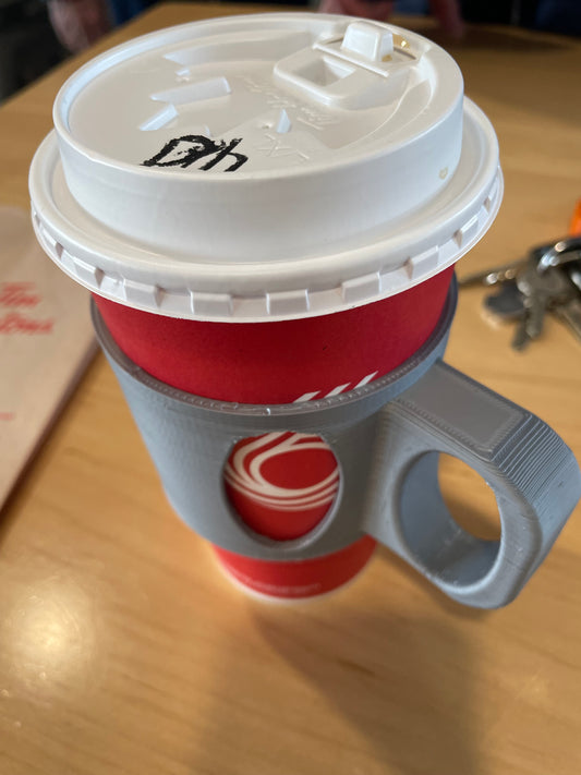 Red coffee cup with white lid and 3D printed gray handle.