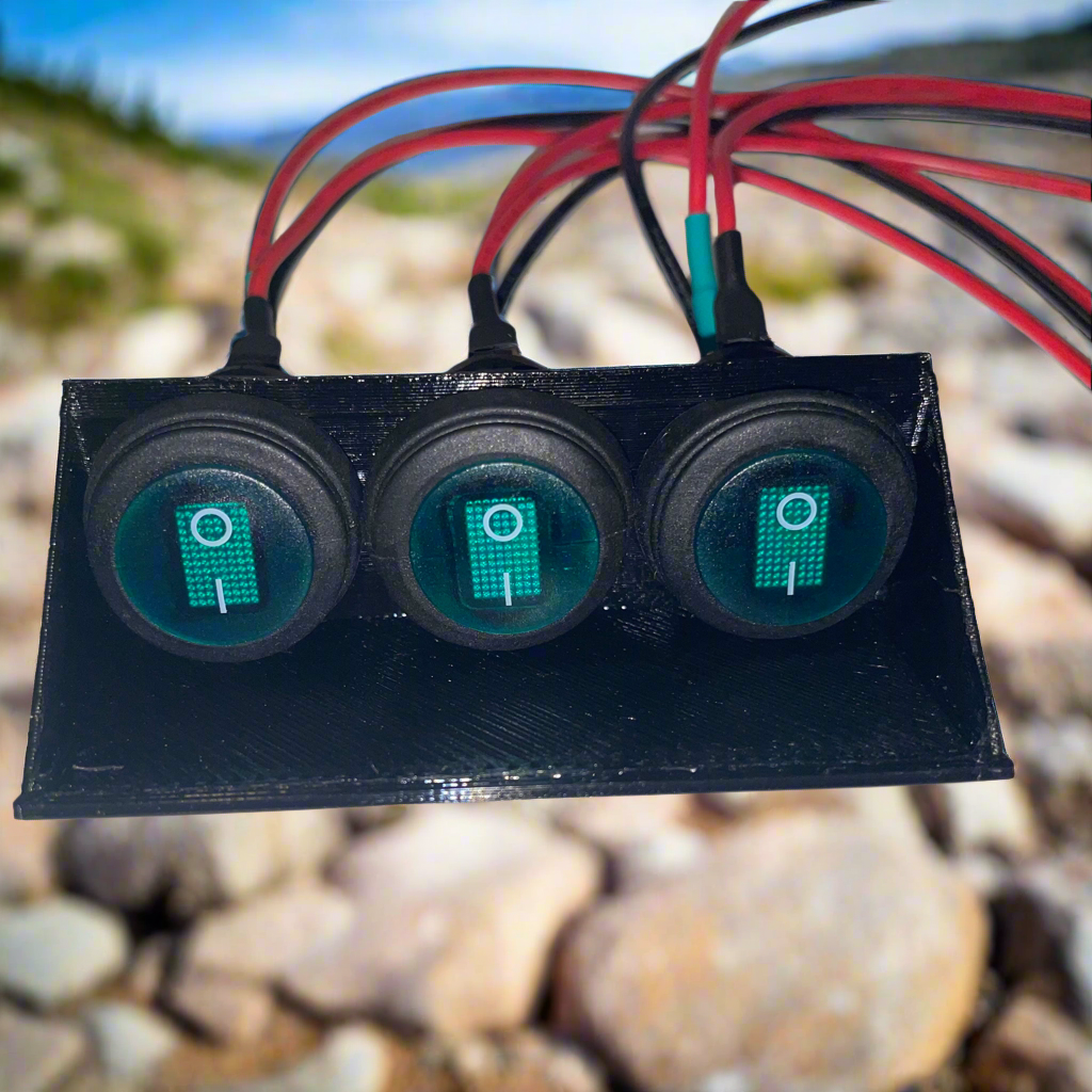 Three green illuminated rocker switches mounted on a black rectangular base with wiring.