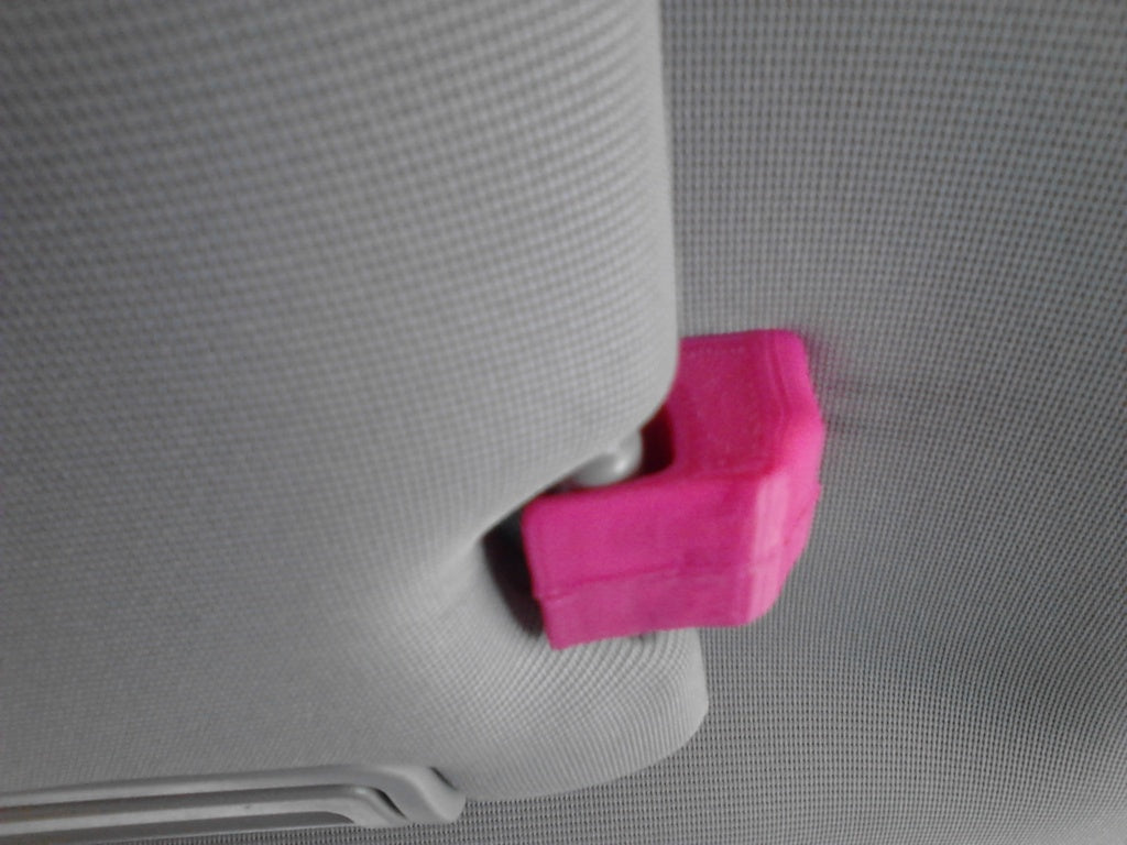 Pink visor clip attached to a car's sun visor.