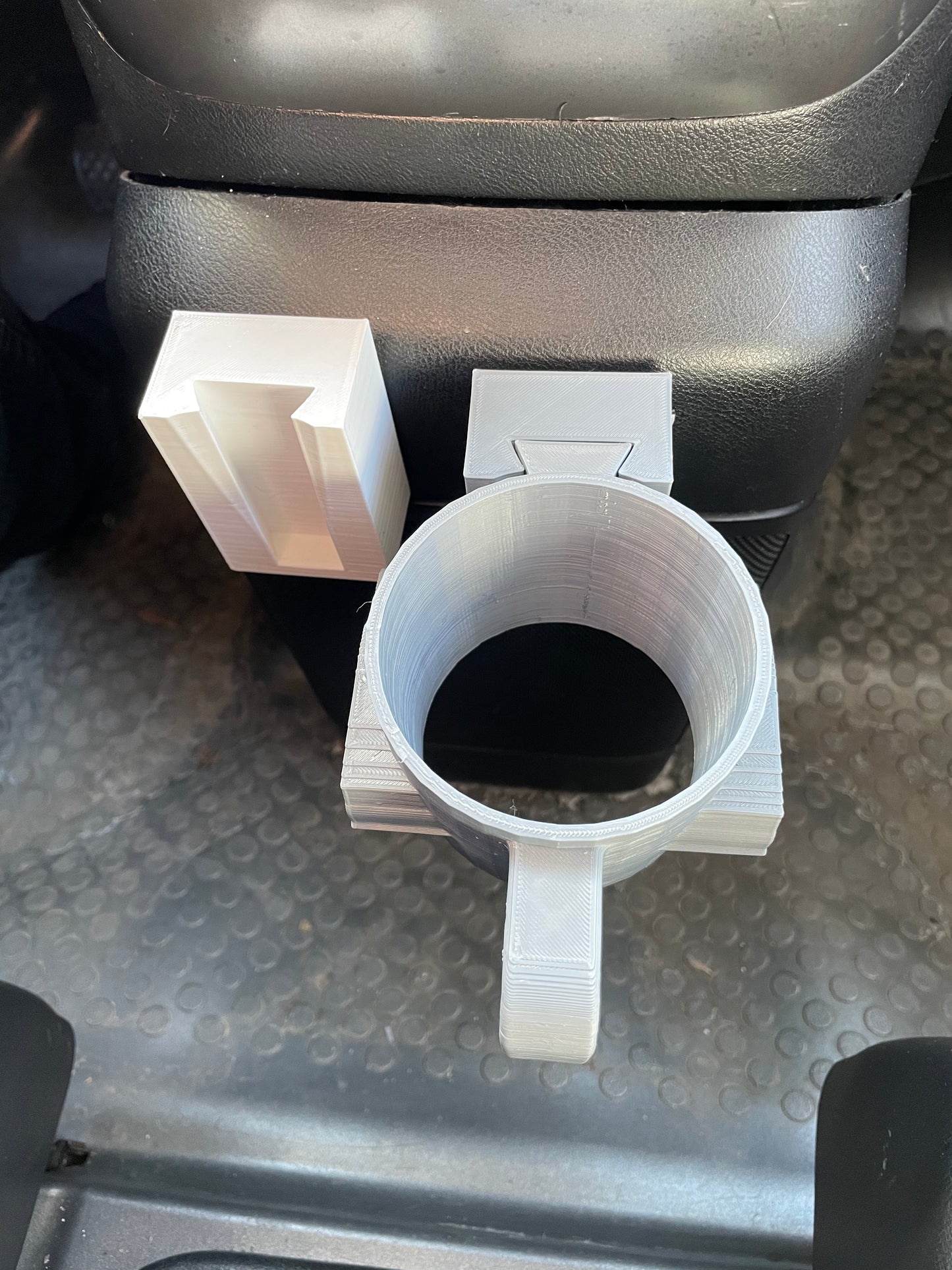 3D printed car accessories: cup holder and phone stand.