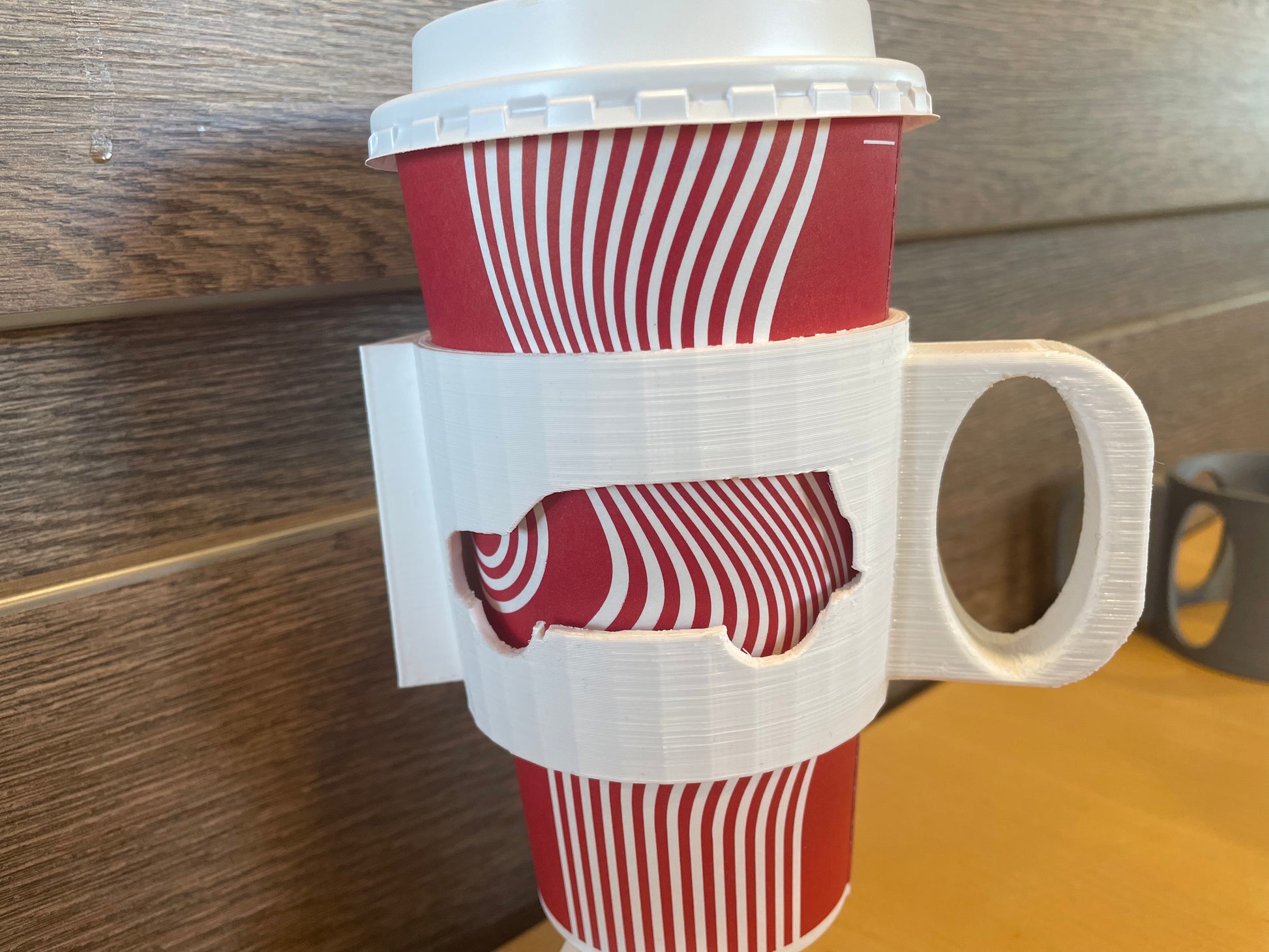 Red and white striped paper cup with a white 3D printed handle.