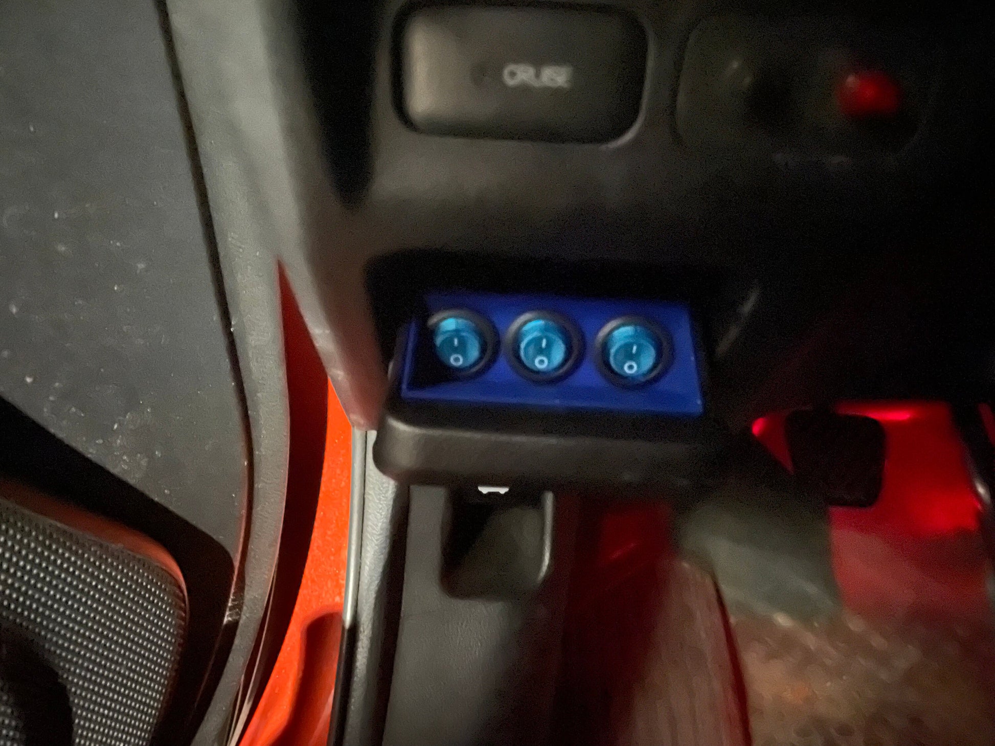 Honda Element coin tray switch bracket with three blue toggle switches.